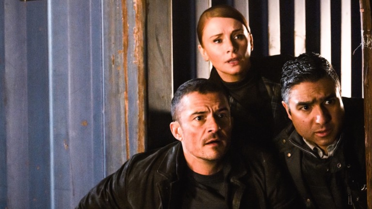 Bryce Dallas Howard as KAT, Orlando Bloom as MARLON, Nick Mohammed as HUGH in DEEP COVER. Credit: Lara Cornell / COPYRIGHT © 2024 COPERTURA PRODUCTIONS LTD. ALL RIGHTS RESERVED.